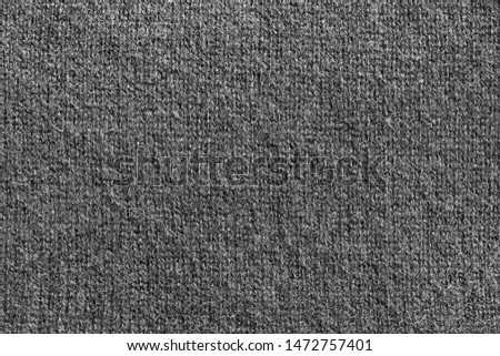 Black wool knitted texture closeup as a background
