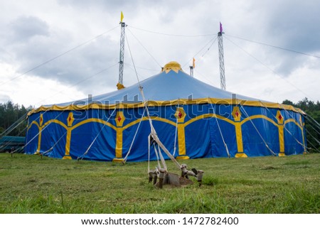 Photo of a mobile blue top circus in the summer forest