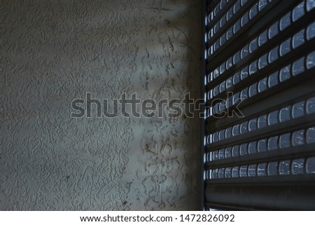 closed garage door with concrete wall