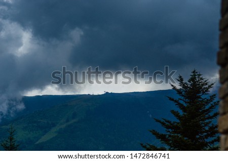Ski lift and Rainy Clouds on The mountain background. Rain is beginning.
