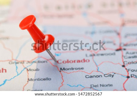 Red clerical needle on a map of USA, Colorado and the capital Denver. Closeup Map Colorado with Red Tack, United States map pin