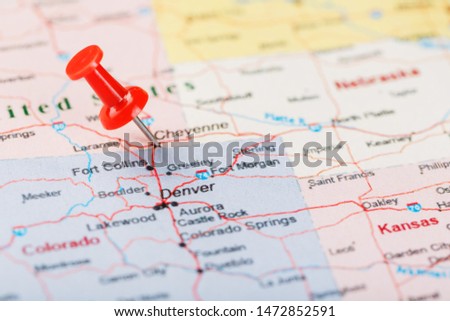 Red clerical needle on a map of United States, Wyoming and the capital Cheyenne. Close up map of wyoming with red tack, US map pin