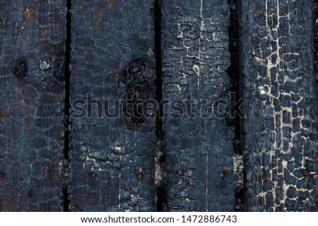 Black burnt wooden background Textured board Selective focus