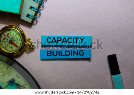 Capacity Building text on sticky notes isolated on office desk