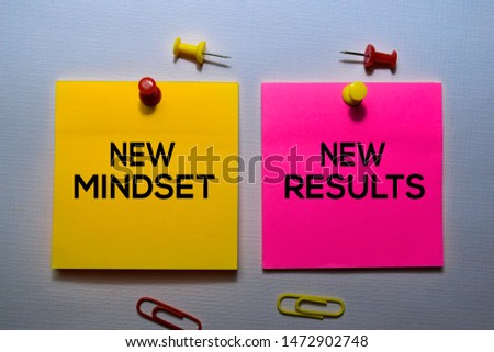 New Mindset - New Results text on sticky notes isolated on office desk