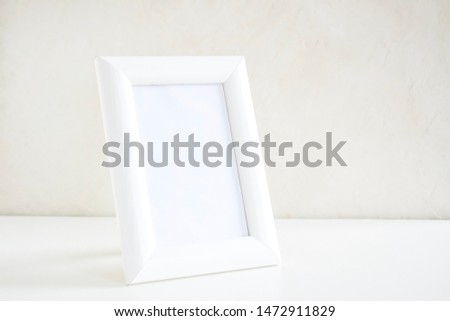 White wooden photo frames in the interior on a white background