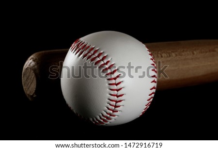 Baseball and wooden bat isolated on black background