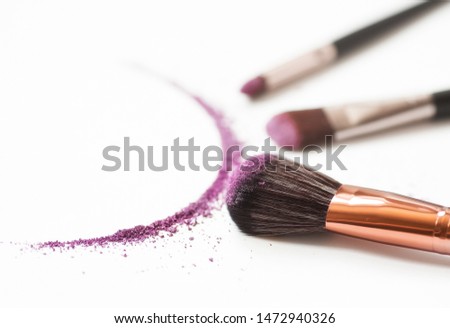 Shadows and makeup brush isolated on white.