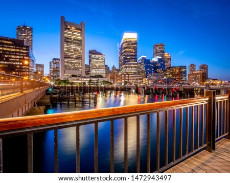 Panoramic view of the city of Boston in Massachusetts, USA at night showcasing its mix of contemporary and historic architecture by Seaport Boulevard.