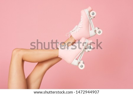 Beautiful shapely legs isolated on the pink background.