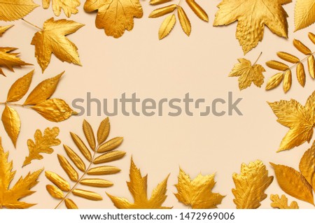 Flat lay creative autumn composition. Frame from Golden leaves on beige background top view copy space. Fall concept. Autumn background. Minimal concept idea, floral design