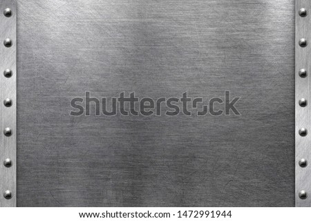 Brushed iron plate, metal frame with steel rivets Royalty-Free Stock Photo #1472991944