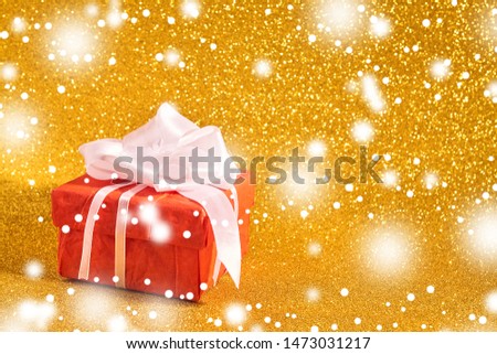 Gift box on gold background. With place for text - Image