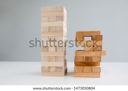 Wood block tower with architecture model, Concept Risk of management and strategy plan, growth business success process and team work.