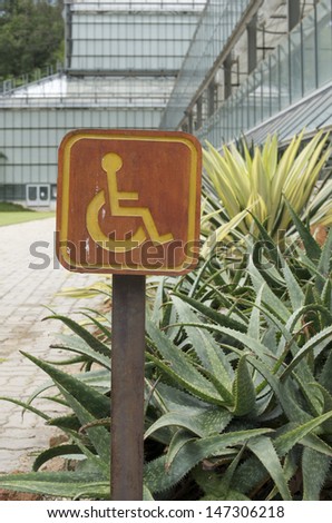 wooden accessible disabled parking sign 