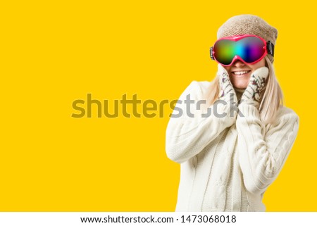 Woman Skier Standing at Snow Looking . Winter yellow, orange, background