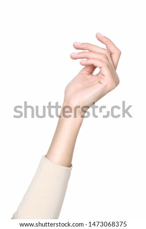 Beauty and health topic: beautiful elegant female show hand gesture on a white background in studio. Elegant female hands. Beautiful fingers. Natural manicure.