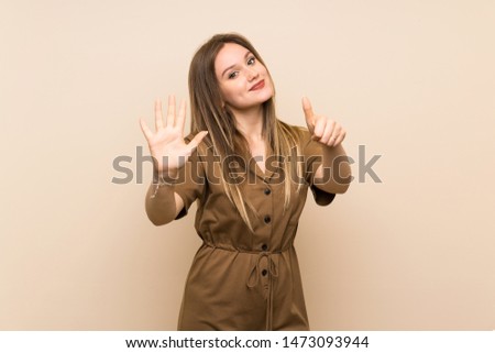 Teenager girl over isolated background counting six with fingers