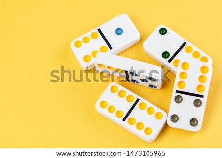 Domino on yellow background photo for your leisure projects or board games publications. Close-up.
