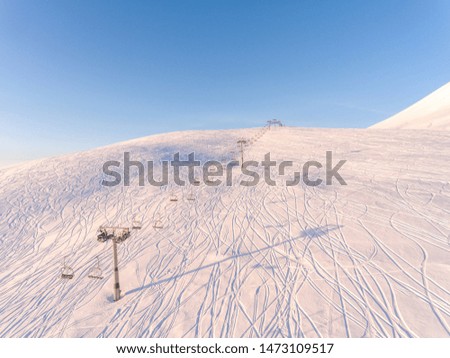 Aerial view people of a cable car on snow slope in winter ski resort