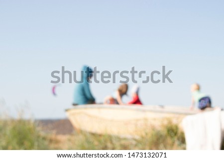 blurred background with family on kitesurf beach