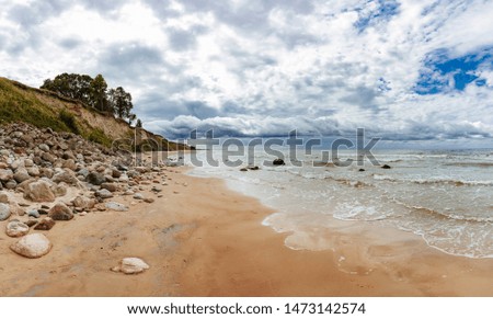 Rocky coast line of the Baltic sea in Latvia, during sunny summer day with blue sky.