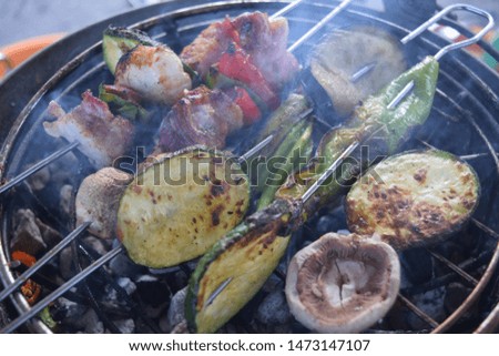 Crispy barbecued hand prepared skewers with meat and vegetables close up 
