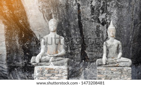 Beautiful 2 stone Buddha on stone background,religion,copy space
