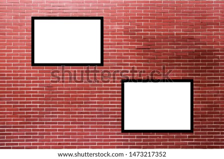 White signs on dark brown brick walls are used as advertising banners or picture frames.