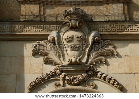 The Three Crowns coat of arms, a symbol of Sweden, on the Kungliga Slotten Royal Palace in Stockholm, Sweden