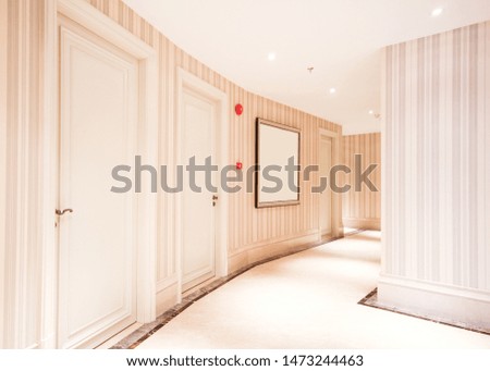 A modern hotel corridor with a picture on the wall