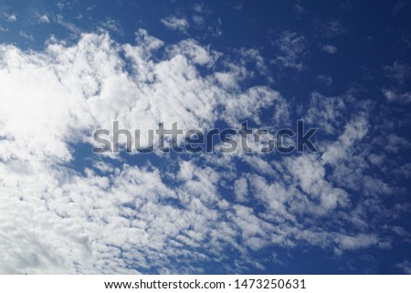 Beautiful cloudscape pattern. The fluffy white clouds moving  in clear bright day. Natural cloud pattern in the blue sky background.