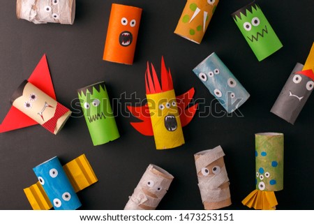 Collection of Monsters from toilet tube roll for halloween decor. A terrible craft. School and kindergarten. Handcraft creative idea, seasonal autumn holiday pattern