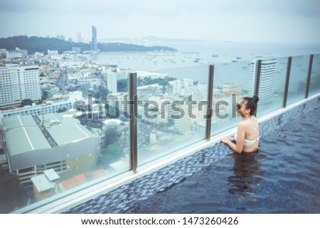 Swimming pool on roof top with beautiful city view, seascape city view, Pattaya, Thailand