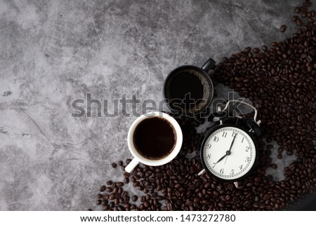 black and white coffee mugs on cement texture background. morning coffee concept.