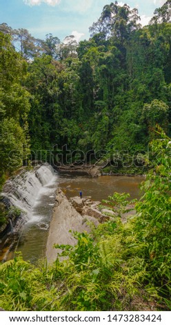 Imbak Falls or Muddy 30m-wide waterfall in rainforest, located at the entrance to Imbak Canyon, Tongod, Sabah - Borneo, Malaysia. Borneo Tropical Rainforest Waterfall