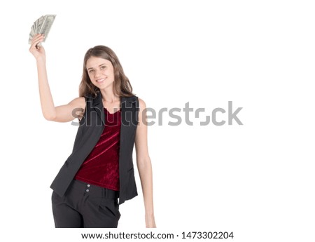 Portrait of a cheerful young woman holding money banknotes and celebrating isolated over white background