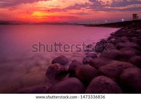 Nature in twilight period which including of sunrise over the lake. Summer lake with blue water and purple sky at the sunset. 