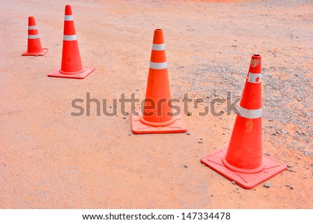 traffic orange road cones, orange traffic cones placed in laterite
