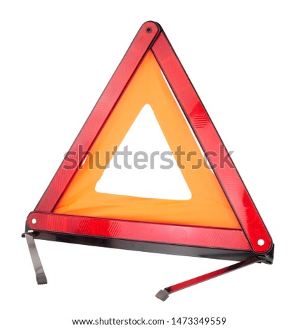 Emergency reflective car warning triangle used to warn others of a broken down vehicle, a legal requirement in most European countries, isolated on a white background