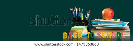 Inscription BACK TO SCHOOL. Still life with school supplies. Green background. Notebooks, notebooks, felt-tip pens, colored pencils, an apple. Colorful picture. Copy space
