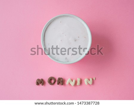 berry yogurt and cereal letters (inscription "morning) on pink
