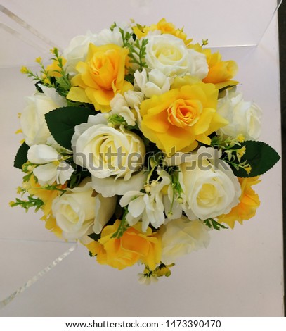 Artificial plastic rose, Yellows and white