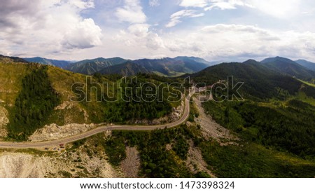 A landscape view of beautiful fresh green forest, road  Chui tract and  Altai mountain background.  Panoramic view of beautiful green forest in the Altai mountains