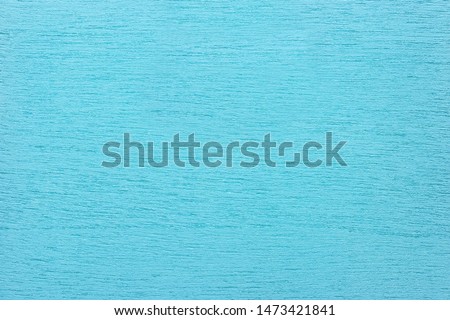 Texture of light blue clean woody background, closeup. Structure of turquoise painted wood, plywood backdrop.
