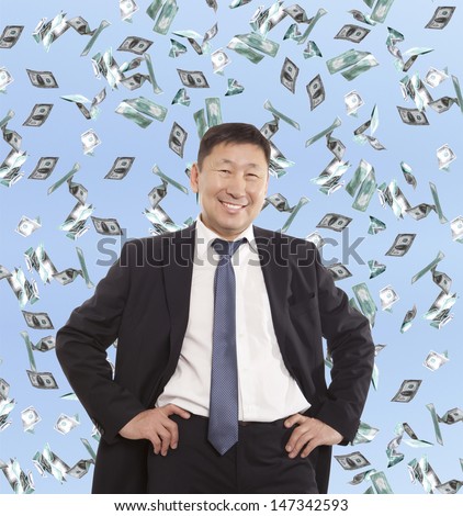 Asian happy businessman and flying dollar banknotes against blue sky