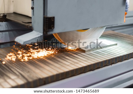 Work of an industrial surface grinding machine. Grinding of a flat metal part. Sparks fly out from under the grinding wheel. Royalty-Free Stock Photo #1473465689