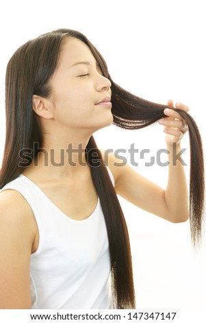 Beautiful young woman touching her hair