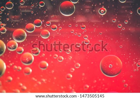 Oil drops in water. Defocused abstract psychedelic pattern image red colored. Abstract background with colorful gradient colors. DOF.