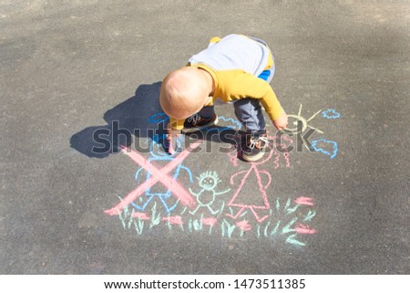 Children's drawing with colorful chalk on the asphalt, family with no dad. Son crossed out father. Family divorce topic.